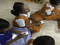 Children with vision impairment play a game to find their partners in an activity camp.