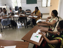 5 students from stella maris college close their eyes and feel tactile books given to them.