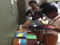 Children with vision impairment pick tactile books to read in activity camp.