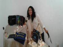 Teresa Antony stands beside her tactile books created as part of a final project at University.