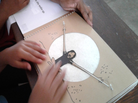 A young boy explores a tactile tree in the adapted story ‘The Giving Tree’.