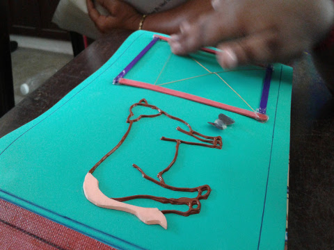 A young boy explores a tactile illustration of a cow.