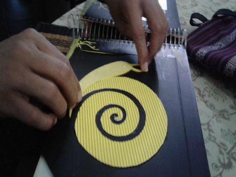 A young girl explores a picture of a tactile snail.